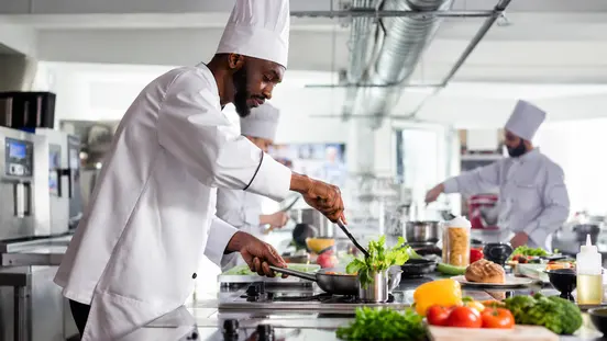 Professional chef preparing food in a commercial kitchen